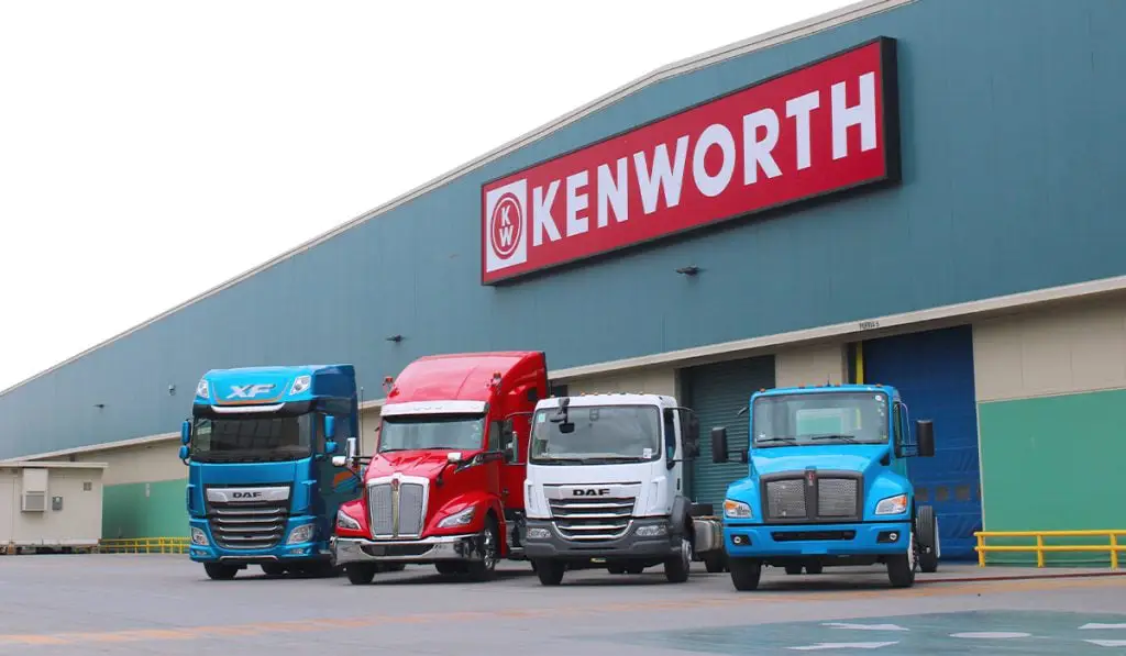 Display lot of Kenworth and DAF semi-trucks